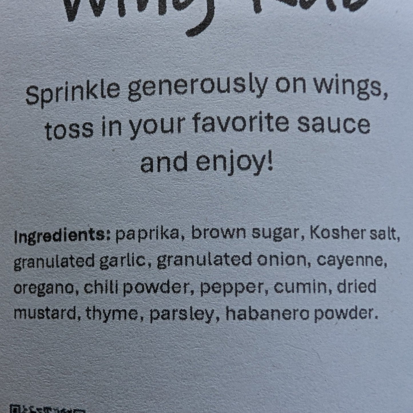 Label for 'Born' Wing Rub on a brown background