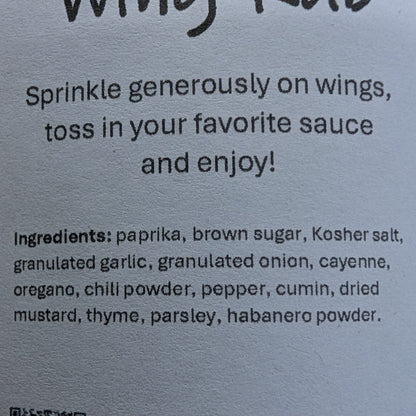 Label for 'Born' Wing Rub on a brown background