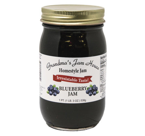 Jar of Grandma's Jam House Blueberry Jam with a gold lid on a white background