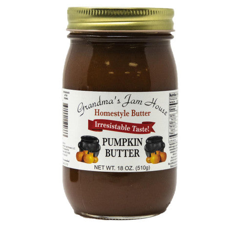 Jar of pumpkin butter with a gold lid on a white background