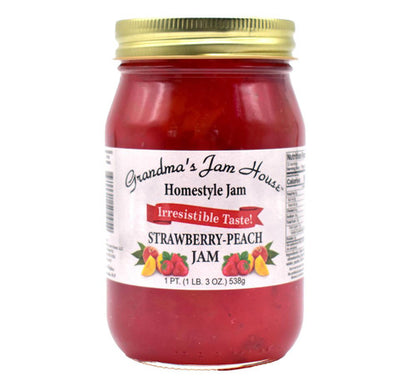 Jar of strawberry-peach jam with a gold lid on a white background