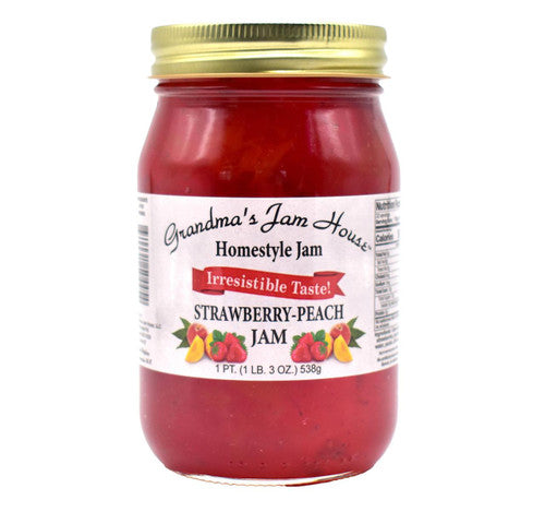 Jar of strawberry-peach jam with a gold lid on a white background